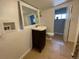 Updated bathroom with a vanity, toilet, and large mirror at 1522 Tamarac St, Denver, CO 80220
