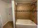 Clean bathroom with a shower/tub combo and tile surround at 1522 Tamarac St, Denver, CO 80220