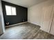 Spacious bedroom with dark accent wall and laminate wood flooring at 1522 Tamarac St, Denver, CO 80220