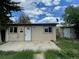 Ranch style home with a spacious front yard and detached garage at 1522 Tamarac St, Denver, CO 80220