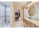 Bathroom with accessible shower, double vanity, and granite at 5219 Royal Pine St, Brighton, CO 80601