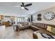 Spacious living room with L-shaped sectional sofa and hardwood floors at 5219 Royal Pine St, Brighton, CO 80601