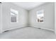 Bright and airy bedroom with carpet flooring and two large windows at 3801 Freestone Pt, Castle Rock, CO 80108