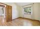 Bright bedroom with hardwood floors and large window at 1058 W Choke Cherry Dr, Louisville, CO 80027