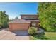 Front view of two-story home with attached two-car garage at 1058 W Choke Cherry Dr, Louisville, CO 80027