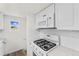 White kitchen with gas range and microwave at 7511 Leyden St, Commerce City, CO 80022