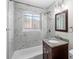 Updated bathroom with marble tile and granite vanity at 6325 Martin Luther King Jr Blvd, Denver, CO 80207