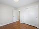 Bedroom with hardwood floors, door to hallway and double closets at 6325 Martin Luther King Jr Blvd, Denver, CO 80207