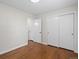 Bedroom with hardwood floors, door to hallway and double closets at 6325 Martin Luther King Jr Blvd, Denver, CO 80207