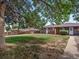 Large backyard with grassy area and shade tree at 6325 Martin Luther King Jr Blvd, Denver, CO 80207