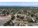 Aerial view of a residential area with houses, streets, and green spaces, offering a wide perspective of the surroundings at 6325 Martin Luther King Jr Blvd, Denver, CO 80207