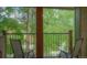 Private balcony with chairs overlooks a tree-filled landscape at 465 Four Oclock Rd # 323, Breckenridge, CO 80424
