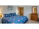 Comfortable bedroom with a dresser and blue bedding at 465 Four Oclock Rd # 323, Breckenridge, CO 80424