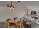 Bright dining area with wood table and chairs, adjacent to kitchen at 465 Four Oclock Rd # 323, Breckenridge, CO 80424