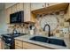 Kitchen details, featuring a unique tile backsplash and double sink at 465 Four Oclock Rd # 323, Breckenridge, CO 80424