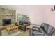 Relaxing living room with a stone fireplace and ample seating at 465 Four Oclock Rd # 323, Breckenridge, CO 80424