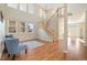 Open and airy living room with high ceilings, wood floors, and a view of the entryway at 16815 Cedar Ridge Ct, Parker, CO 80134