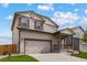 Two-story house with gray siding, attached garage, and landscaping at 7302 Arkansas Street, Frederick, CO 80530