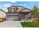 Two-story house with gray siding, attached garage, and landscaping at 7302 Arkansas Street, Frederick, CO 80530
