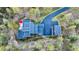 Overhead view of modern home, detached garage, and paved driveway at 32651 Buffalo Creek Rd, Evergreen, CO 80439