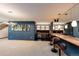 Basement bar with sleek cabinetry and mirrored backsplash at 32651 Buffalo Creek Rd, Evergreen, CO 80439