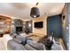 Finished basement Gathering room with stone fireplace, large TV and comfortable seating at 32651 Buffalo Creek Rd, Evergreen, CO 80439
