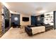 Finished basement Gathering room with stone fireplace, large TV and comfortable seating at 32651 Buffalo Creek Rd, Evergreen, CO 80439