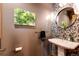 Modern powder room with mosaic tile and a pedestal sink at 32651 Buffalo Creek Rd, Evergreen, CO 80439