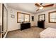 Charming bedroom with ceiling fan, dresser, and views of trees from windows at 32651 Buffalo Creek Rd, Evergreen, CO 80439