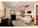 Spacious bedroom with ceiling fan, dresser and a bed with floral bedding at 32651 Buffalo Creek Rd, Evergreen, CO 80439