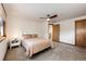 Bright bedroom with ceiling fan, and a double bed with beige bedding at 32651 Buffalo Creek Rd, Evergreen, CO 80439