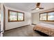 Comfortable bedroom with ceiling fan, large windows, and ample floor space at 32651 Buffalo Creek Rd, Evergreen, CO 80439