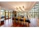 Open concept dining room with hardwood floors, modern light fixtures, and patio access at 32651 Buffalo Creek Rd, Evergreen, CO 80439