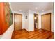 Bright hallway with hardwood floors and access to multiple rooms at 32651 Buffalo Creek Rd, Evergreen, CO 80439