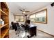 Bright home office with built-in shelving, desk, and comfortable seating at 32651 Buffalo Creek Rd, Evergreen, CO 80439
