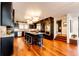 Modern kitchen with island, stainless steel appliances, and hardwood floors at 32651 Buffalo Creek Rd, Evergreen, CO 80439