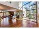 Bright and spacious living room with hardwood floors, stone fireplace, and large windows at 32651 Buffalo Creek Rd, Evergreen, CO 80439