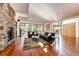 Living room with hardwood floors, stone fireplace, and comfortable seating at 32651 Buffalo Creek Rd, Evergreen, CO 80439