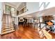 Open concept living area with hardwood floors, modern staircase, and high ceilings at 32651 Buffalo Creek Rd, Evergreen, CO 80439