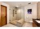 Modern shower with glass enclosure, built-in seat, and multiple shower heads at 32651 Buffalo Creek Rd, Evergreen, CO 80439