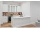 Modern basement wet bar with white cabinetry and quartz countertops at 428 S Williams St, Denver, CO 80209