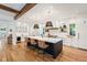 Open concept kitchen with a large island, white cabinetry, and hardwood floors at 428 S Williams St, Denver, CO 80209