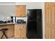 Kitchen with black refrigerator and microwave at 305 Ravine Way, Brighton, CO 80603