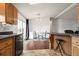 Kitchen with island and view of dining area at 305 Ravine Way, Brighton, CO 80603