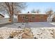 Brick ranch home with a walkway and snow-covered yard at 5860 E 68Th Way, Commerce City, CO 80022