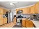 Stainless steel appliances and light wood cabinets in this galley kitchen at 5860 E 68Th Way, Commerce City, CO 80022