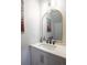 Clean powder room with a modern vanity and arched mirror at 4960 S Lipan Dr, Englewood, CO 80110