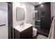 Stylish bathroom with black and white geometric tile and a walk-in shower at 4960 S Lipan Dr, Englewood, CO 80110