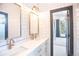 Modern bathroom with white subway tile and gold fixtures at 4960 S Lipan Dr, Englewood, CO 80110