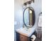 Stylish powder room with a pedestal sink and patterned wallpaper at 4960 S Lipan Dr, Englewood, CO 80110